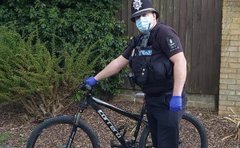 Policeman next to a bike