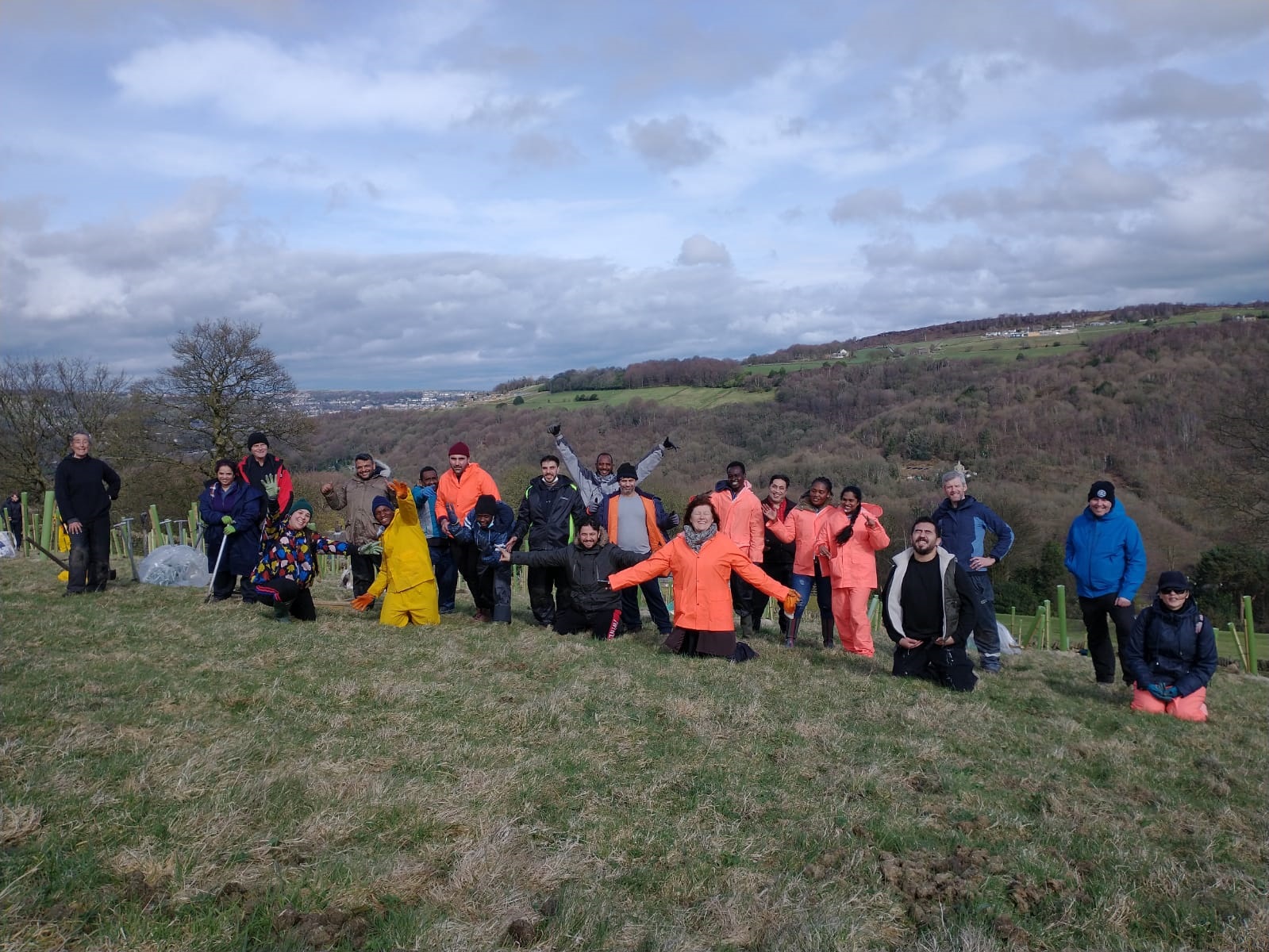 Group of people on a hill planting trees