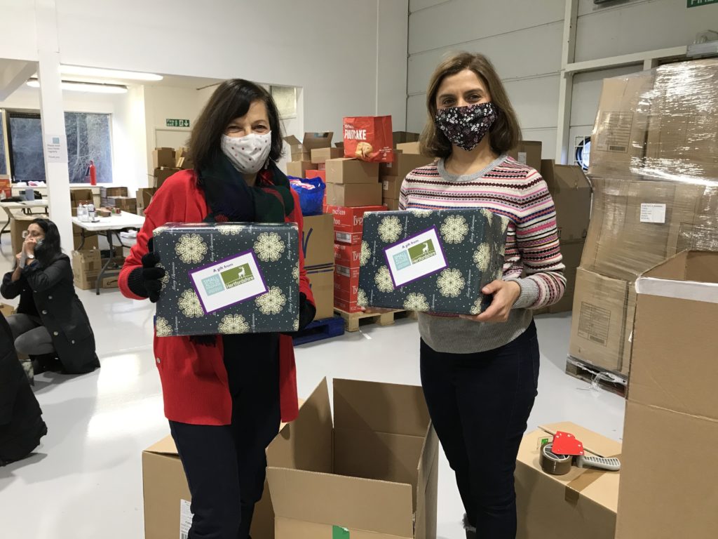 Two women holding gifts